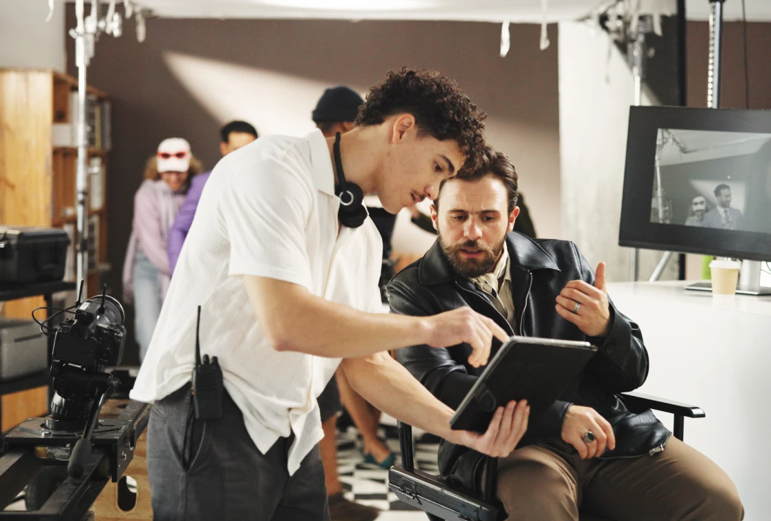 Film crew reviewing footage on tablet