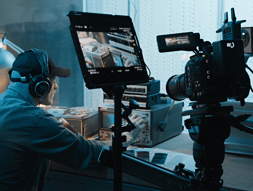 Director adjusting camera settings in studio