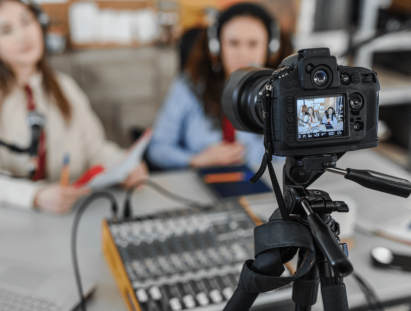 Podcast hosts being recorded on camera