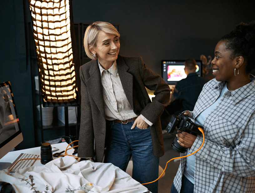 Photographers discussing in a studio setting.