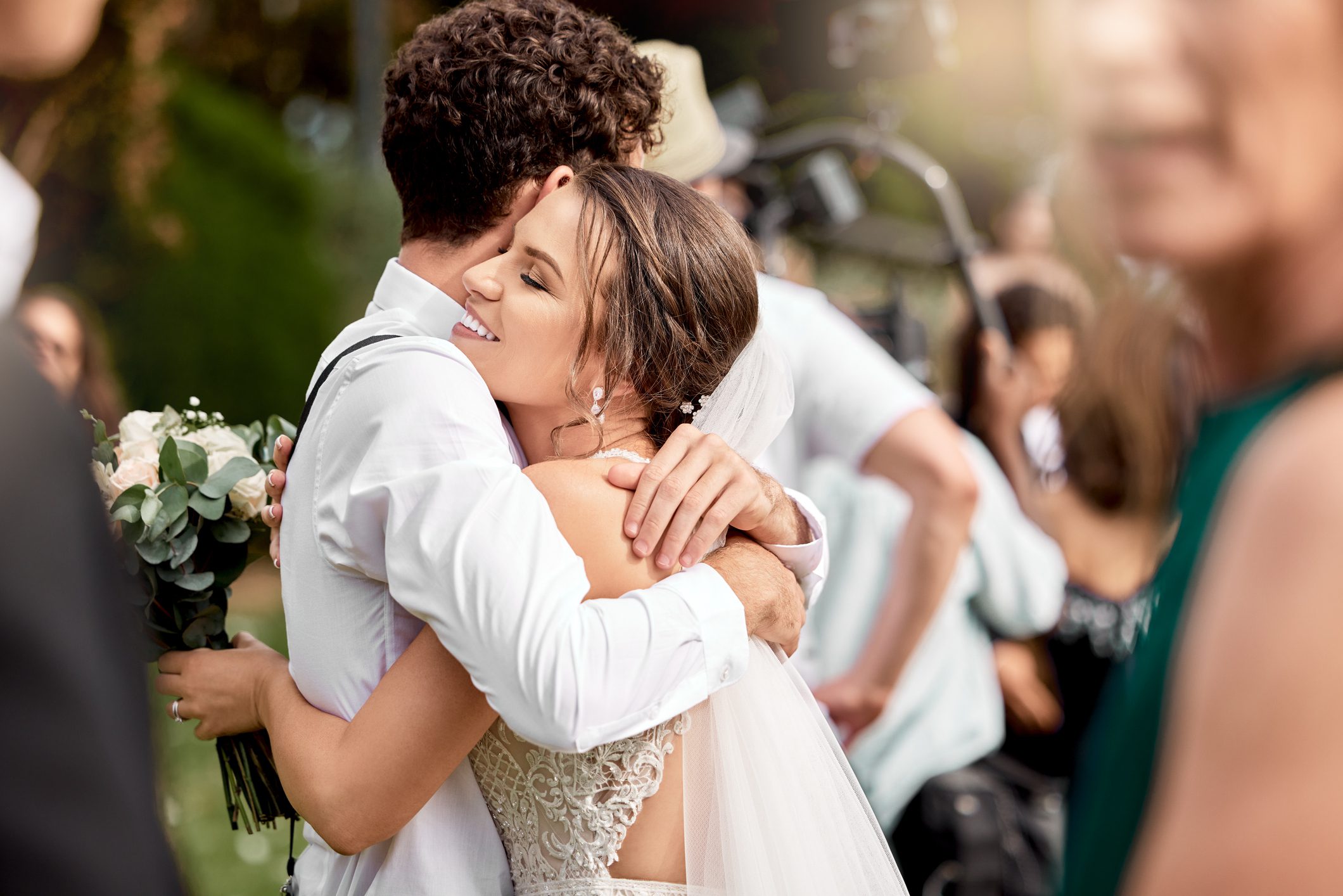Bride and groom hugging at wedding celebration.