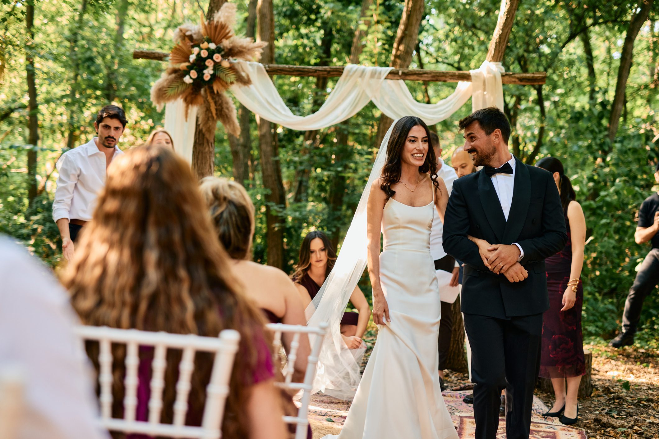 Bride and groom walking at outdoor wedding.